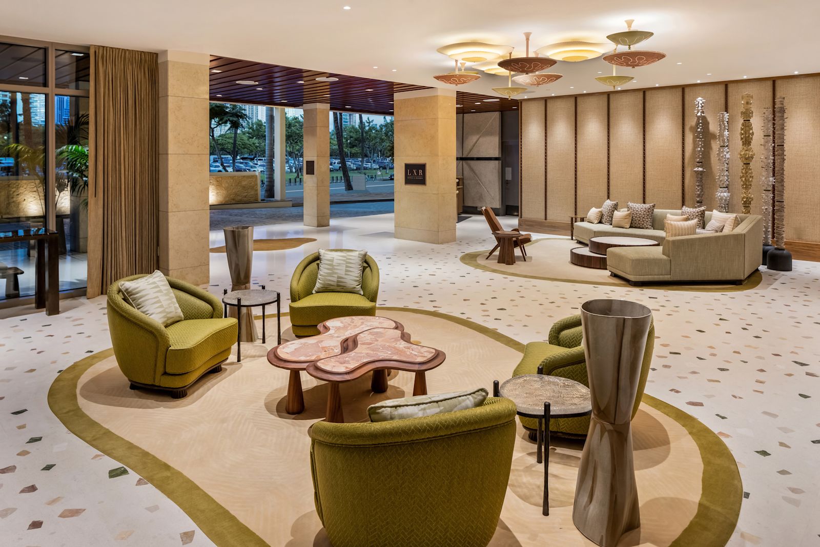 A lobby lounge with green armchairs at Ka La'i Waikiki Beach