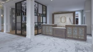 The marble-floored reception at Oberlin Hotel Raleigh, with a wood-front desk and white columns