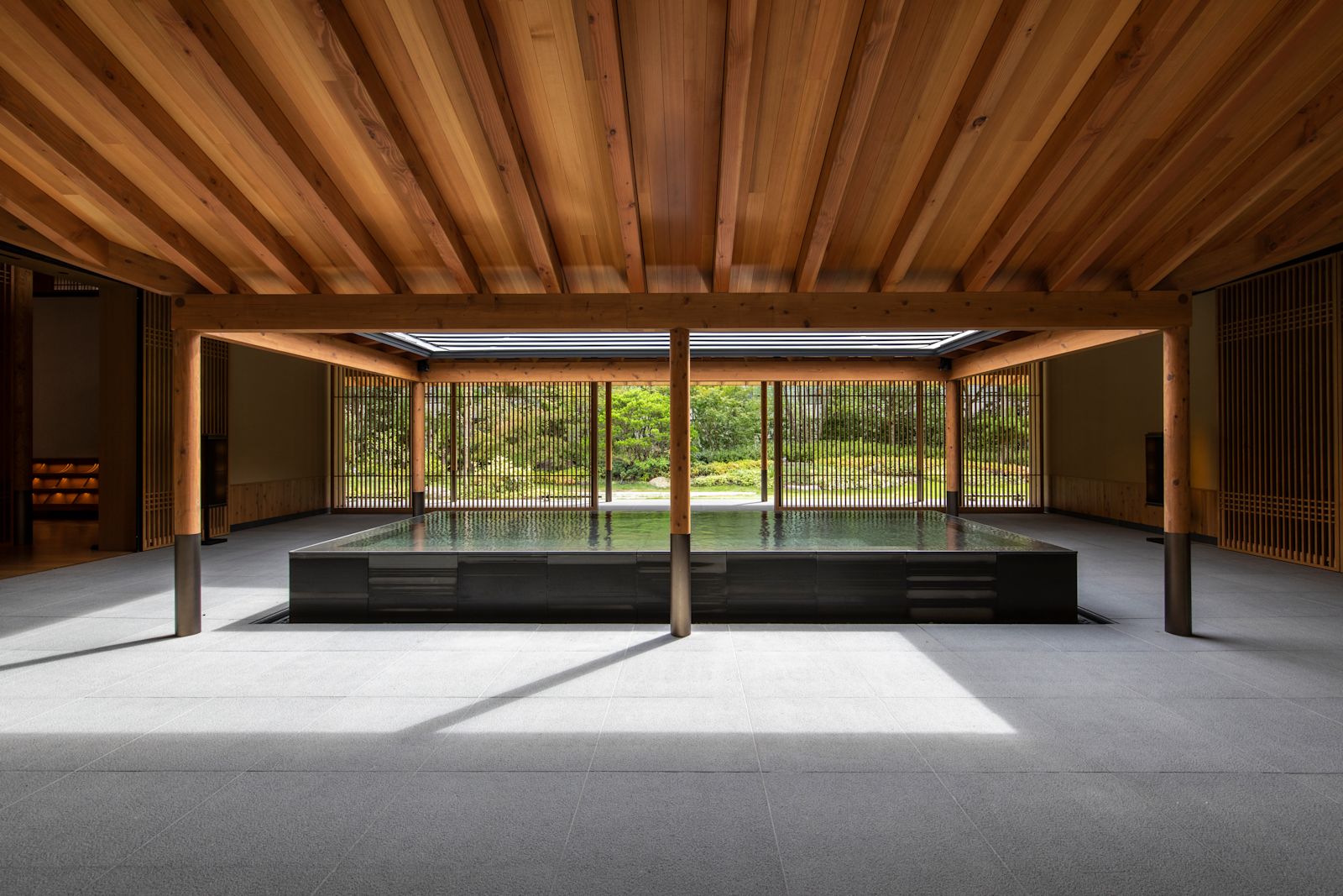 Guest room at ROKU Kyoto with floor-to-ceiling windows over the Takagamine mountains.
