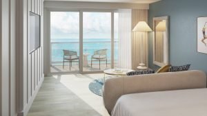 A king room at The Sunny Miami with sliding doors to a balcony over the ocean