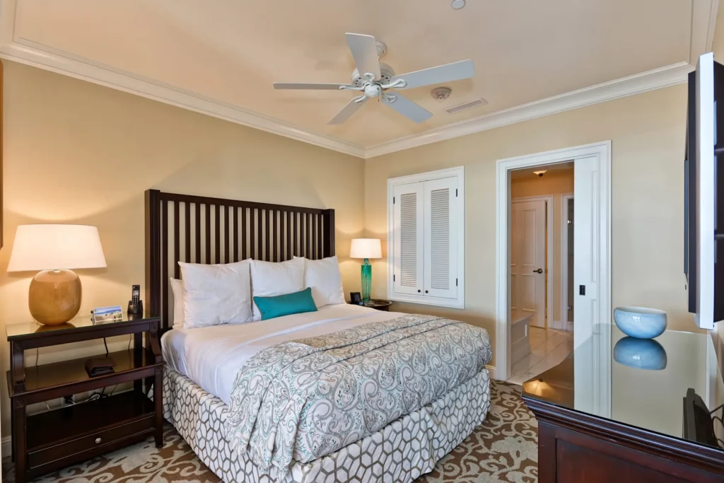 A bedroom with a white bed and ceiling fan at Beach Village at The Del